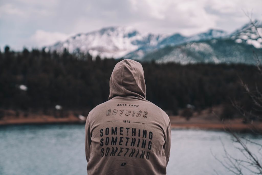 shallow focus photo of person in gray hoodie